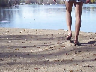 Crossdresser at the lake in hose and heels